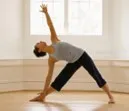 woman doing triangle pose in yoga