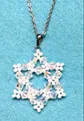 Pendant in shape of snowflake made of cystal beads.