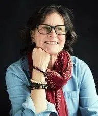 a picture of presenter sitting with her hand under her chin