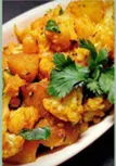 Cauliflower and potato  with onions, tomato and Indian spices on a dish.