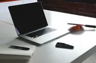 picture of laptop with pen and paper