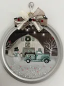 Winter scene with blue pickup truck, snowman, white barn decorated on a pizza pan.