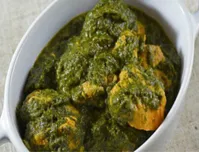 Indian Palak (Spinach) Chicken in a white dish.