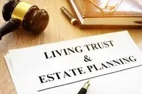 Living Trust and Estate Planning document, gavel and book on a desk.