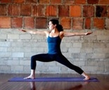 woman in warrior pose on a yoga mat
