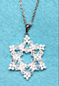 Pendant in shape of snowflake made of cystal beads.