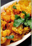 Cauliflower and potato  with onions, tomato and Indian spices on a dish.
