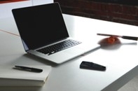 picture of laptop with pen and paper