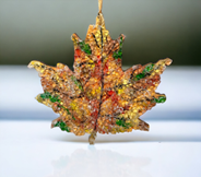 Ornamental leaf made from mosaic beads.