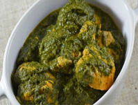 Indian Palak (Spinach) Chicken in a white dish.