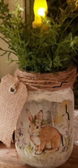 Image of mason jar with bunny painted on it with candle.