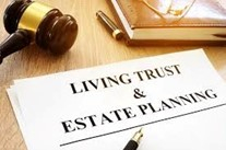 Living Trust and Estate Planning document, gavel and book on a desk.
